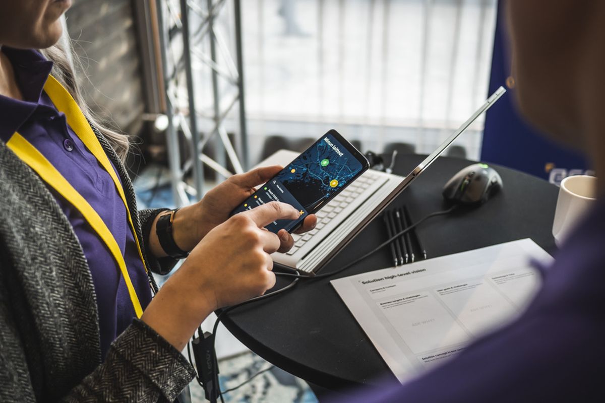 Trade-show booth demo of a field service UI on a phone
