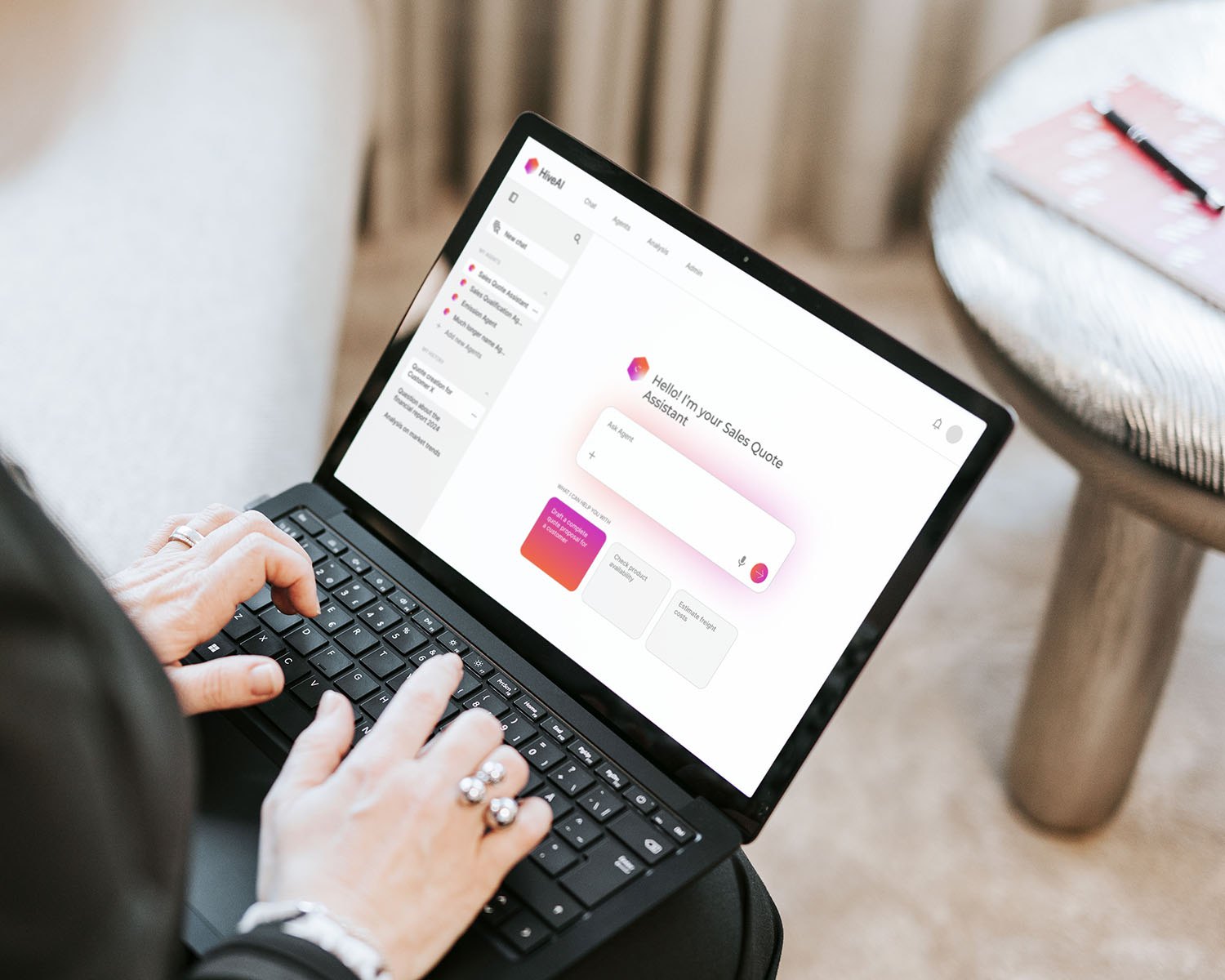 Hands typing on a laptop showing the HiveAI Sales Quote Assistant chat view, with suggested tasks under the prompt